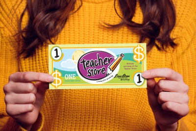 Hand holding two dollar bill. Isolated on a colored sweater. Teacher Buck